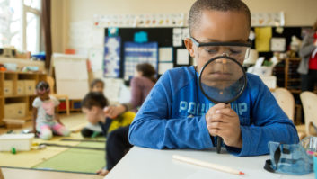 kindergarten student with magnifying glass