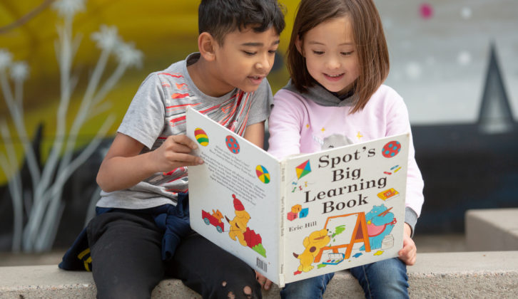 Two students reading a book science of reading