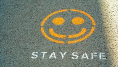 "Safe" and smiley face on pavement for safe schools