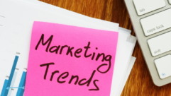 image with the words marketing trends written out on a pink post it note