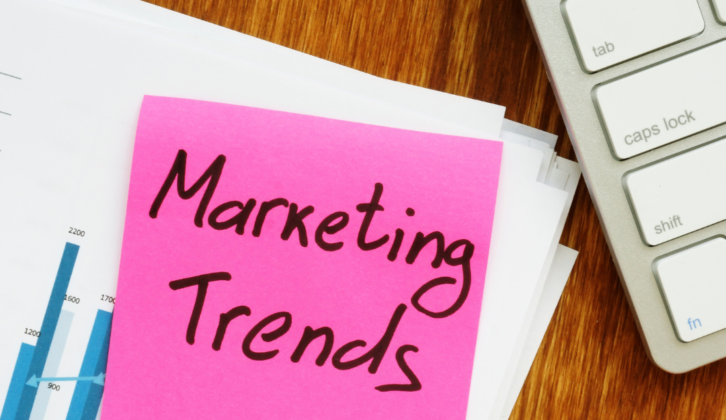 image with the words marketing trends written out on a pink post it note