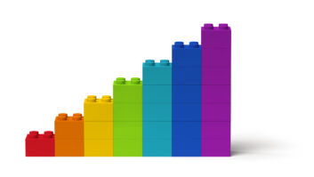 rainbow of large Lego bricks stacked in upward graph representation for article on measuring coaching impact