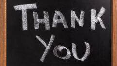 Small blackboard with "thank you" written on it in white chalk for article on gratitude
